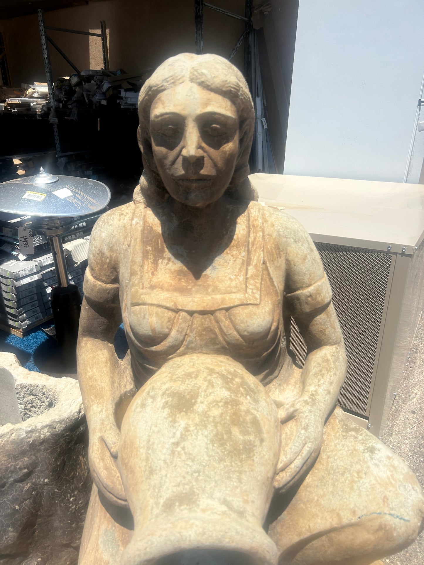 Stone statue of native woman with pitcher water fountain ￼