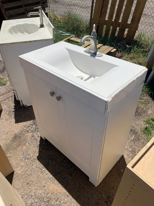 White two door vanity with top and faucet